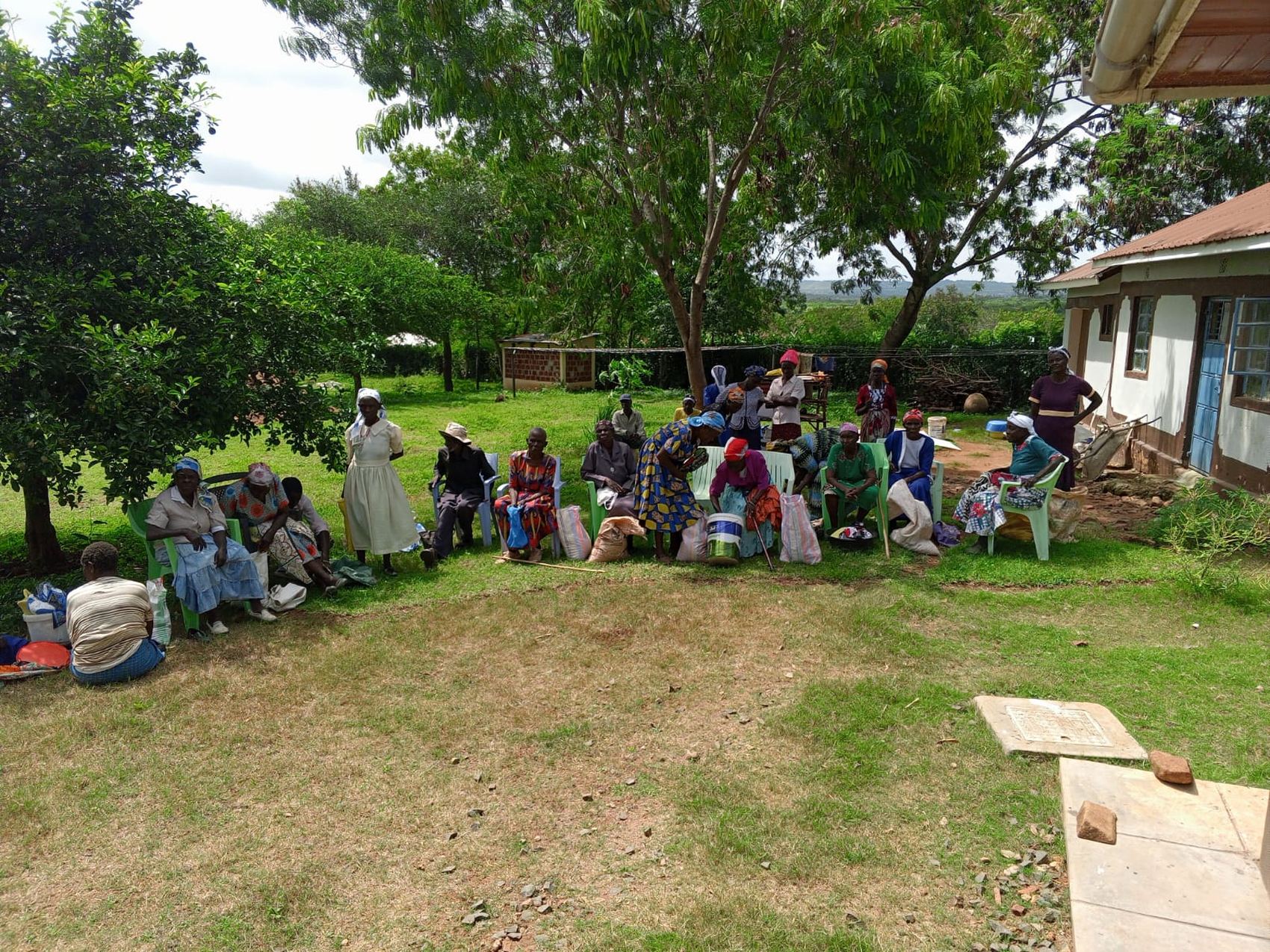 Volunteers and elderly beneficiaries at a Dignity for the Elderly Trust food support day in East Kanyakwar, Kadem, Migori County